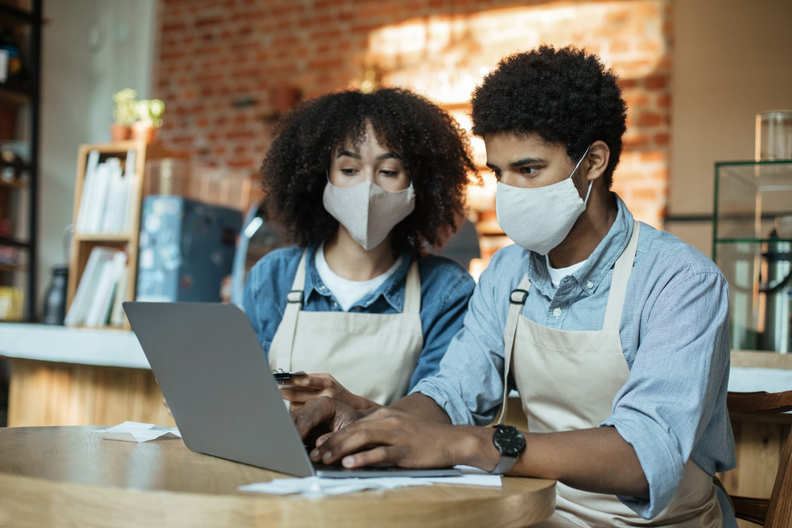 Two essential workers accessing their web presence together.